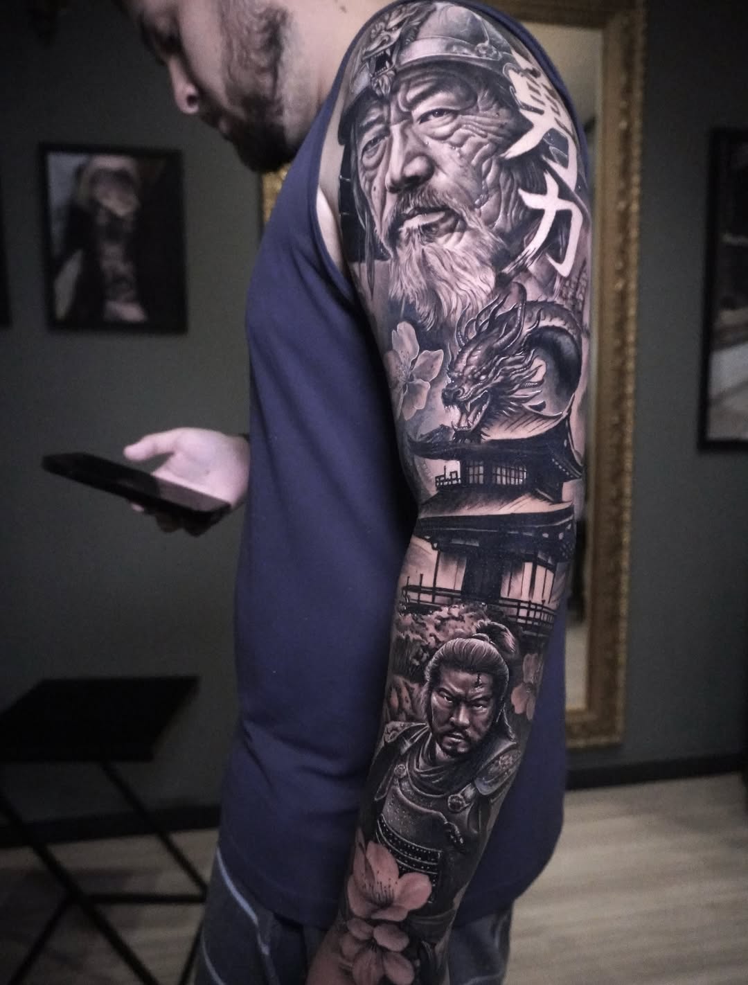 Full arm sleeve with a samurai, dragon and Japanese pagoda in realism