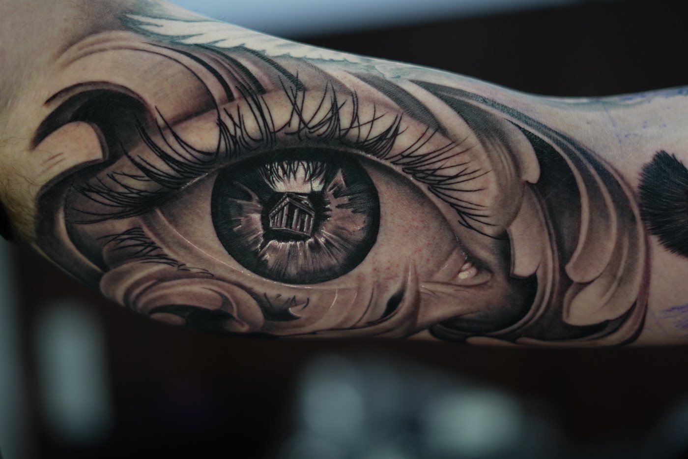Hyperrealistic eye with classical Greek temple reflection in pupil and baroque filigree ornament